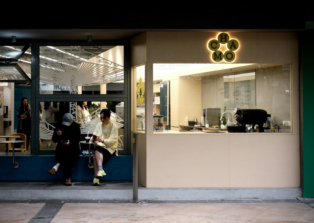 person drinking coffee at cafe