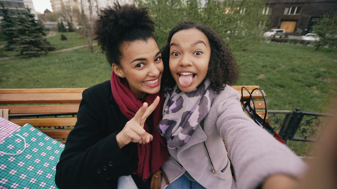 friends laughing on bench